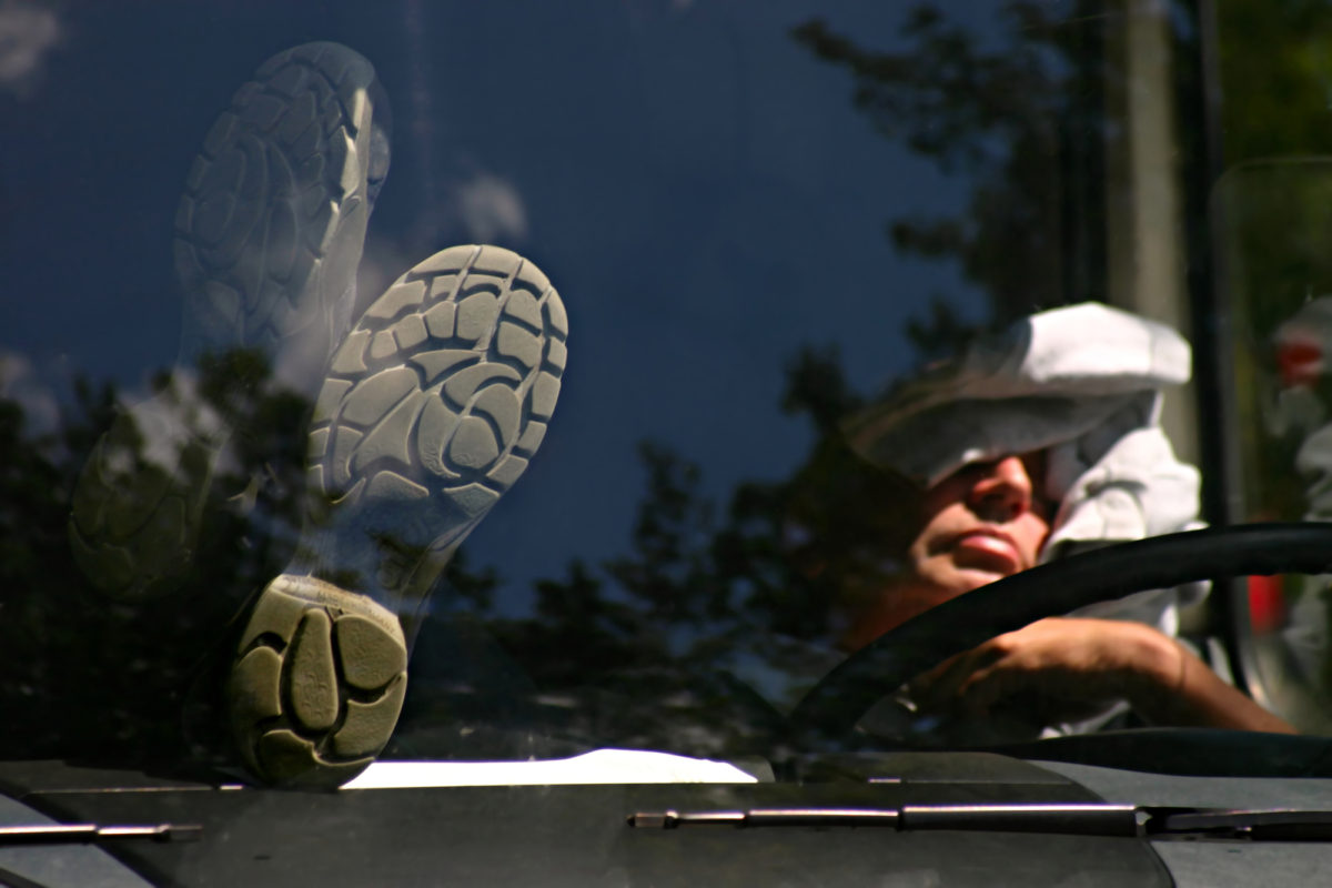 truck driver sleeping in cab of truck