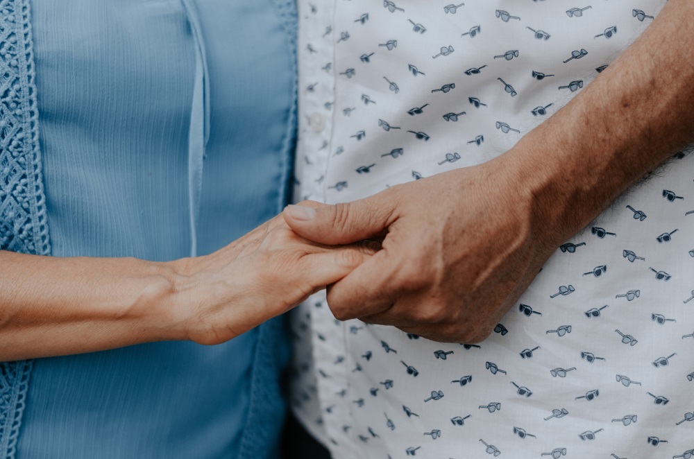 holding hands in hospital garb